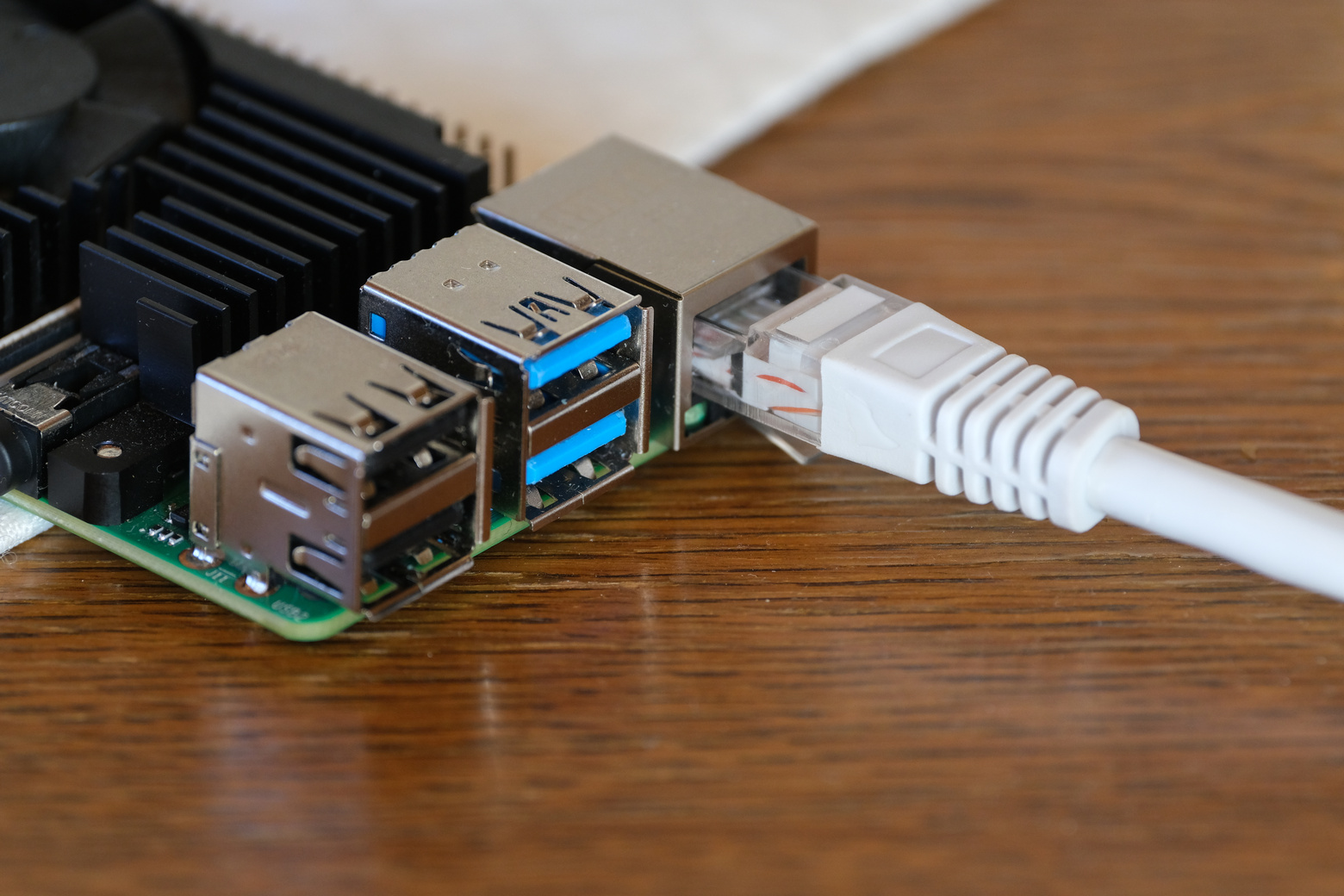 Raspberry Pi with Ethernet cable connected to it.